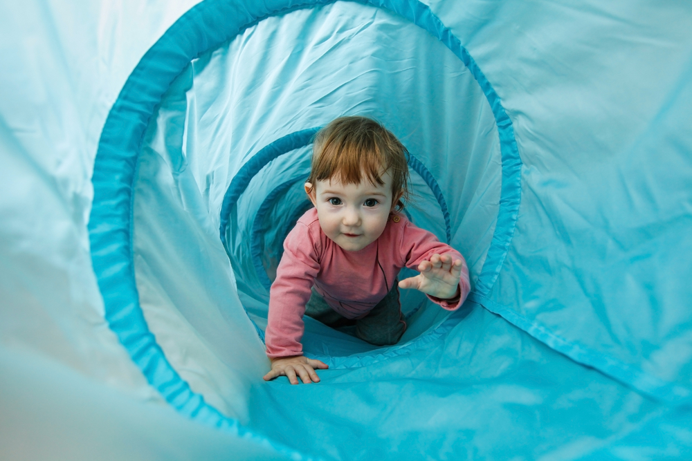 Small,Toddler,Playing,In,A,Tunnel,Tube,,Crawling,Through,It